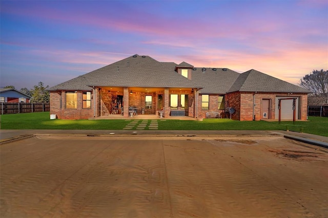 view of front of home featuring a garage and a lawn