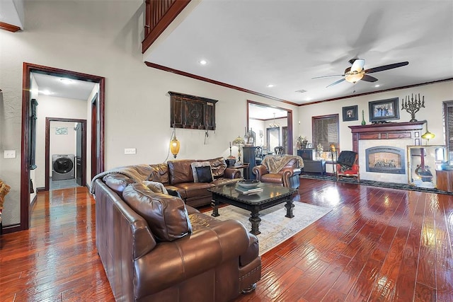 living room with crown molding, ceiling fan, washer / dryer, and hardwood / wood-style floors