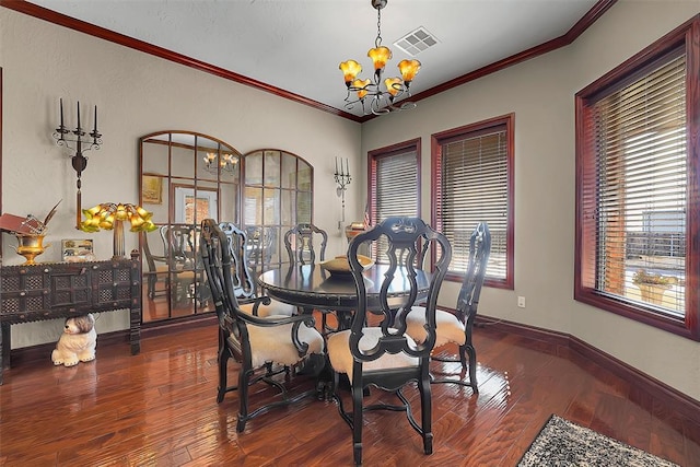 dining area with ornamental molding, dark wood-type flooring, and a notable chandelier