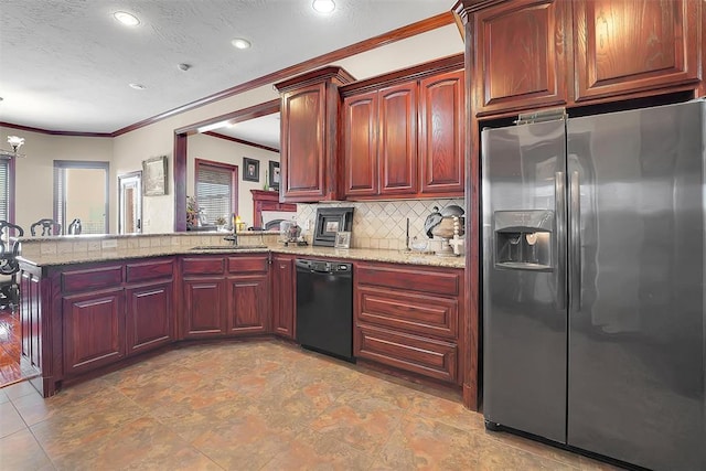 kitchen featuring sink, light stone counters, stainless steel fridge, dishwasher, and kitchen peninsula