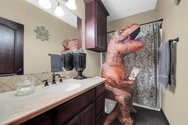 bathroom featuring tile patterned floors, vanity, and backsplash