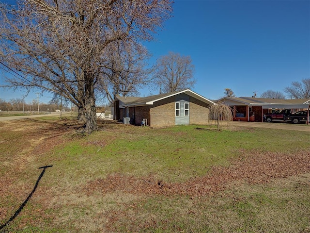 view of home's exterior featuring a carport and a lawn