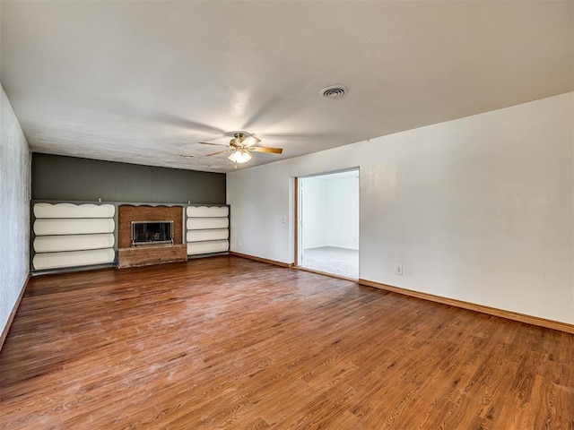 unfurnished living room featuring hardwood / wood-style floors and ceiling fan