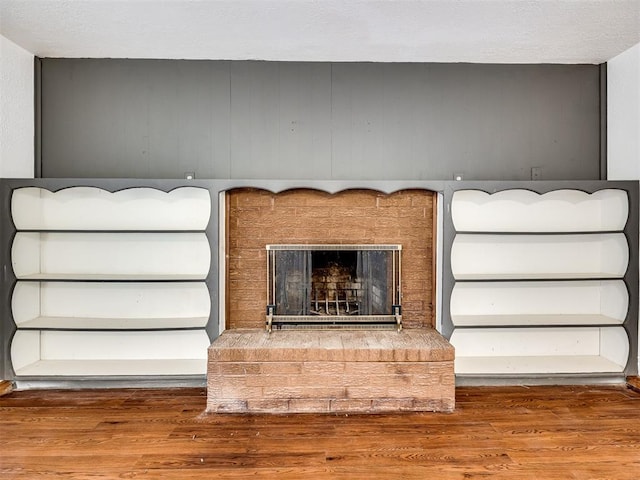 room details featuring hardwood / wood-style floors and a brick fireplace