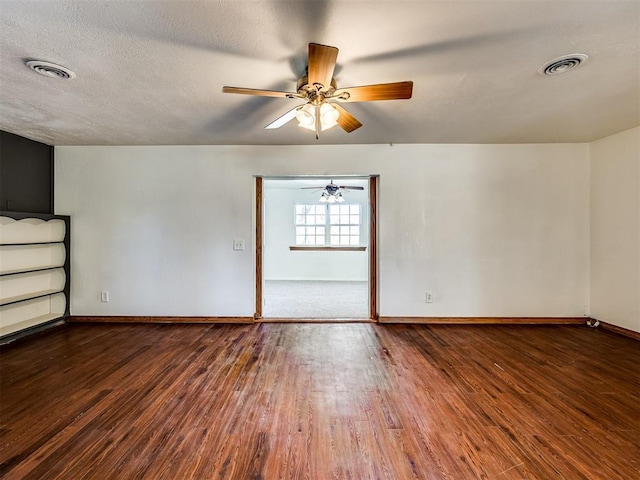 empty room with ceiling fan, hardwood / wood-style floors, and a textured ceiling