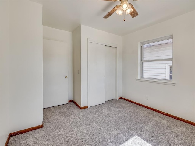 unfurnished bedroom with a closet, ceiling fan, and light colored carpet