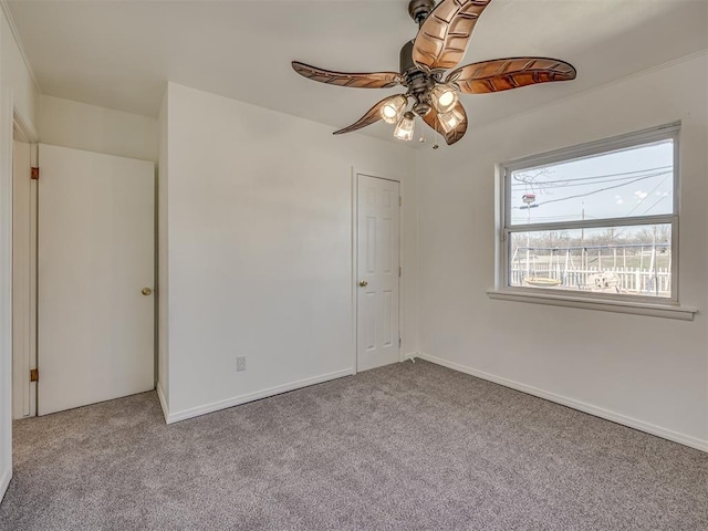 spare room featuring light carpet and ceiling fan