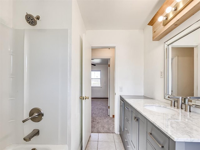 bathroom with bathtub / shower combination, vanity, and tile patterned floors