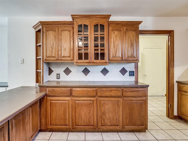 kitchen with decorative backsplash and light tile patterned floors