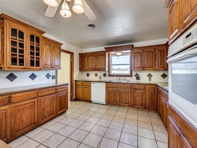 kitchen featuring decorative backsplash, ceiling fan, and white appliances