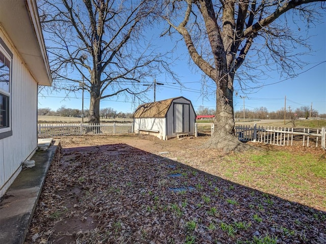 view of yard featuring a rural view and a storage unit