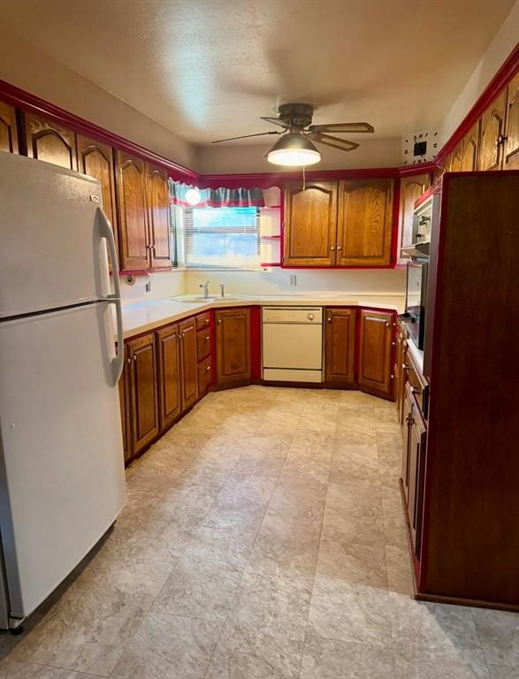 kitchen with ceiling fan, white appliances, and sink