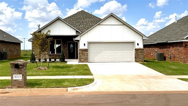 view of front facade featuring central AC unit, a garage, and a front yard