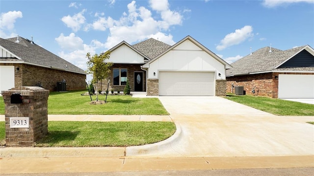 view of front facade with a front yard, a garage, and central AC unit