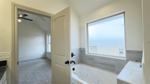 bathroom featuring a tub, ceiling fan, and lofted ceiling