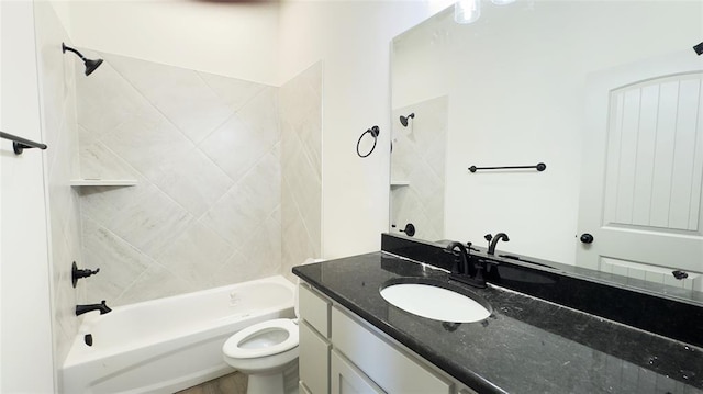 full bathroom with toilet, vanity, and tiled shower / bath