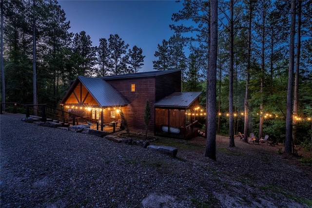 view of back house at dusk