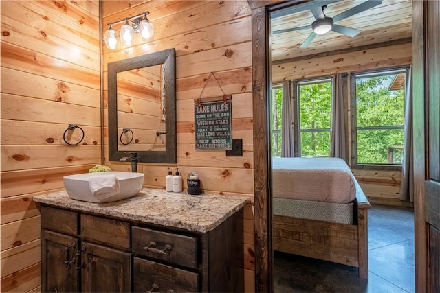 bathroom with vanity, wooden ceiling, tile patterned floors, wooden walls, and ceiling fan