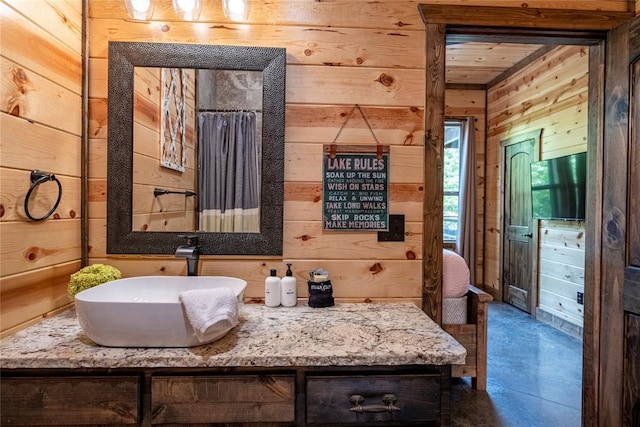 bathroom with wood walls and vanity