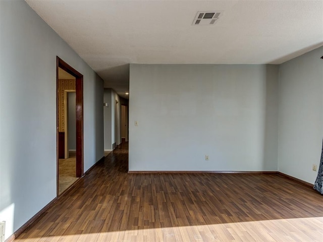 spare room with dark hardwood / wood-style flooring