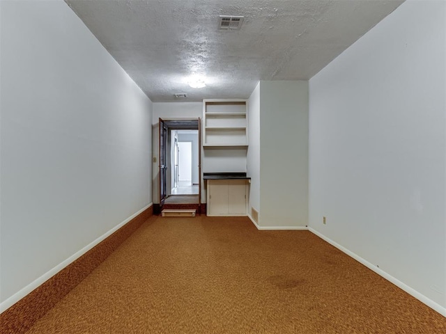 interior space featuring carpet and a textured ceiling