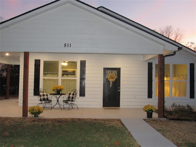 exterior entry at dusk with a patio