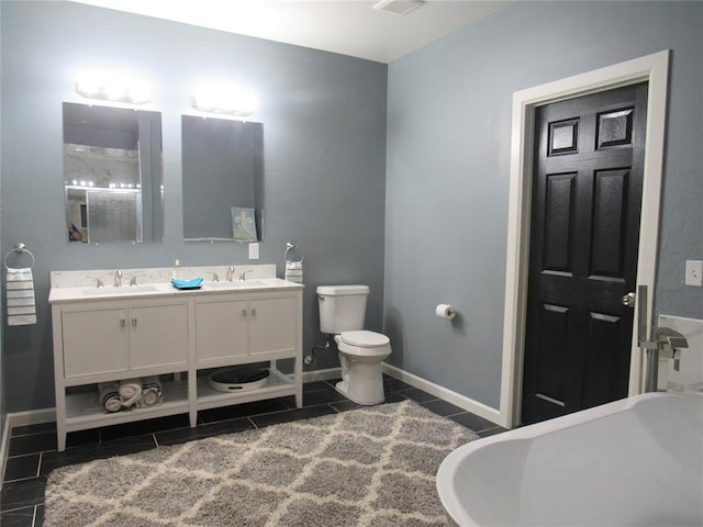 bathroom featuring vanity, toilet, tile patterned flooring, and a bathtub