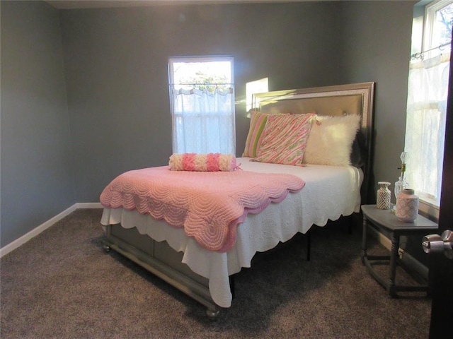 carpeted bedroom featuring baseboards