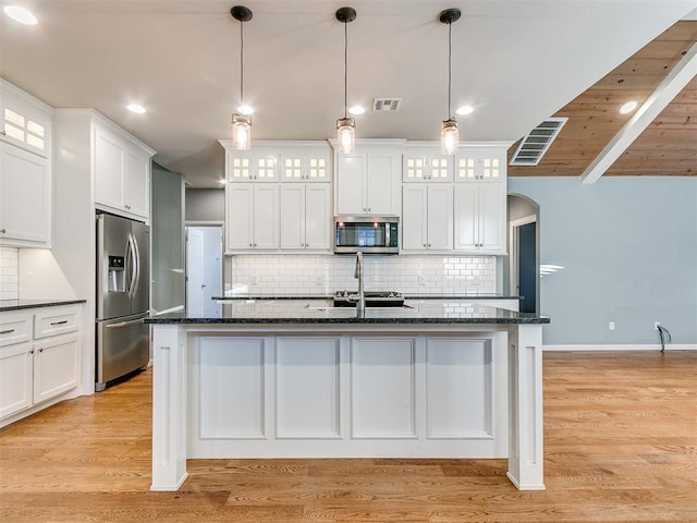 kitchen with white cabinetry, wood ceiling, appliances with stainless steel finishes, and tasteful backsplash