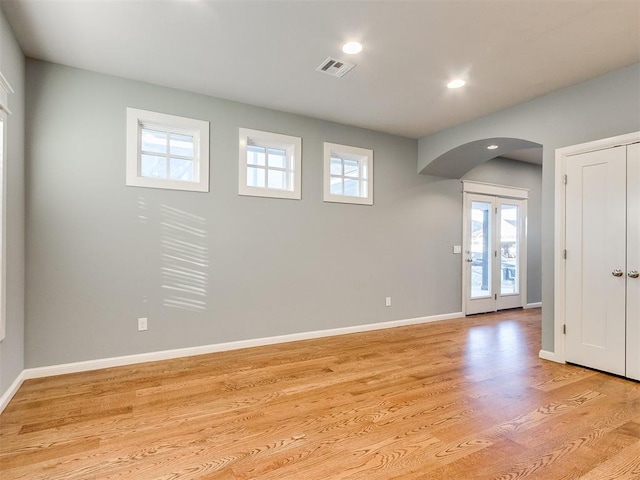 entryway with light wood-type flooring and french doors