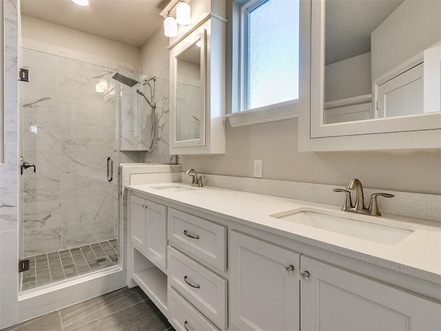 bathroom featuring tile patterned flooring, vanity, and walk in shower