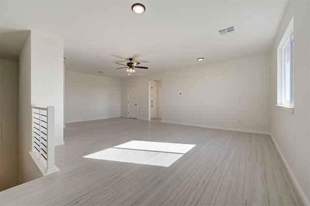 spare room with ceiling fan and light hardwood / wood-style floors