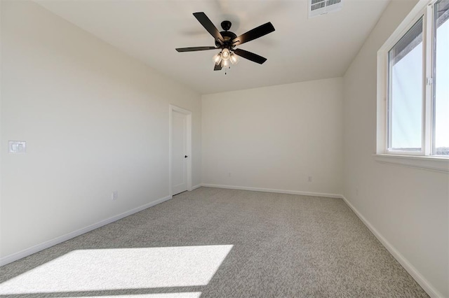 carpeted empty room featuring ceiling fan