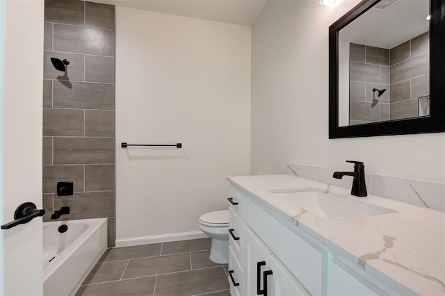 full bathroom with tiled shower / bath, vanity, tile patterned floors, and toilet