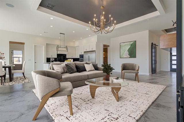 living room with a raised ceiling and a barn door