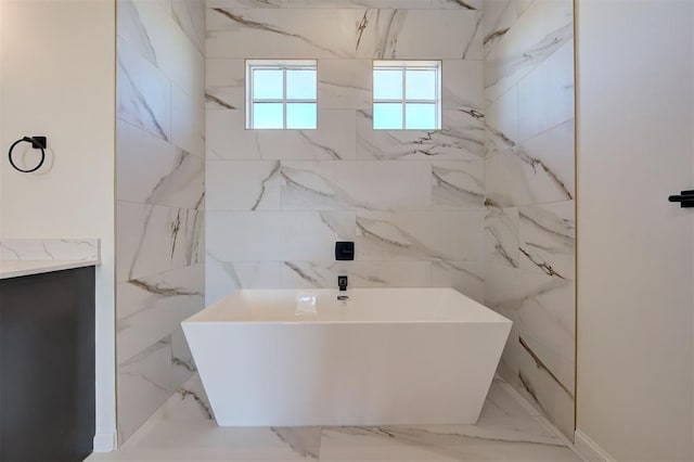 bathroom with vanity and a bath