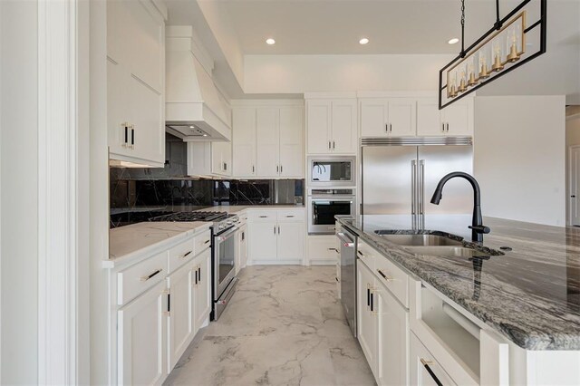 2270 NW 227th St, Edmond, OK 73025 - kitchen with recessed lighting, marble finish floor, built in appliances, a sink, and custom exhaust hood