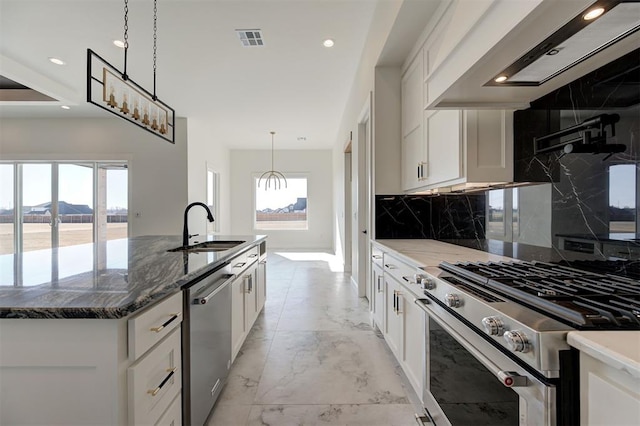 2270 NW 227th St, Edmond, OK 73025 - kitchen with wall chimney range hood, a sink, stainless steel appliances, backsplash, and visible vents