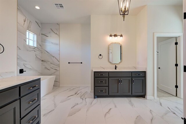 2270 NW 227th St, Edmond, OK 73025 - bathroom featuring a soaking tub, visible vents, marble finish floor, and baseboards