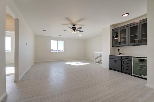 2270 NW 227th St, Edmond, OK 73025 - interior space with light wood finished floors, a sink, wet bar, ceiling fan, and beverage cooler