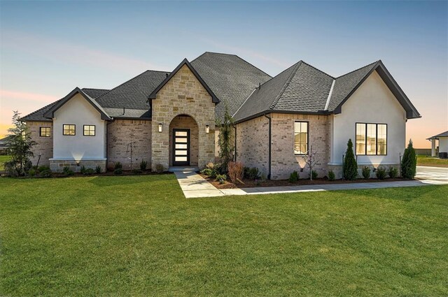2270 NW 227th St, Edmond, OK 73025 - view of front of home with stone siding, brick siding, and a yard