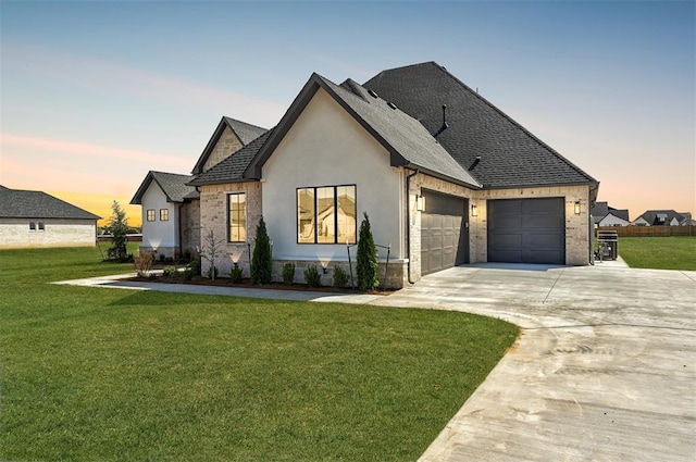 2270 NW 227th St, Edmond, OK 73025 - view of front of property featuring an attached garage, stone siding, a front lawn, and concrete driveway