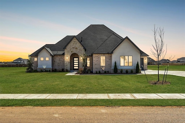 2270 NW 227th St, Edmond, OK 73025 - french country home with a yard, stone siding, and stucco siding