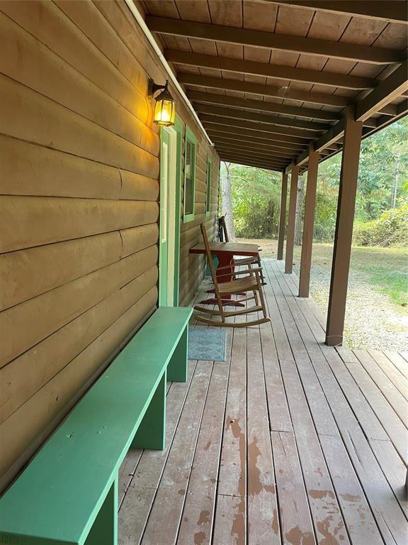 wooden terrace featuring covered porch