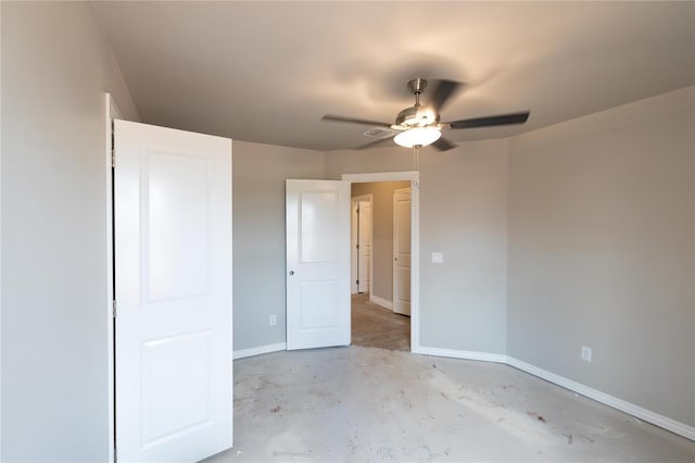 16024 Coneflower Dr, Edmond, OK 73013 - unfurnished bedroom featuring baseboards, concrete floors, and a ceiling fan