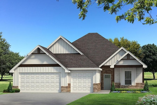 view of front of house featuring a front lawn and a garage