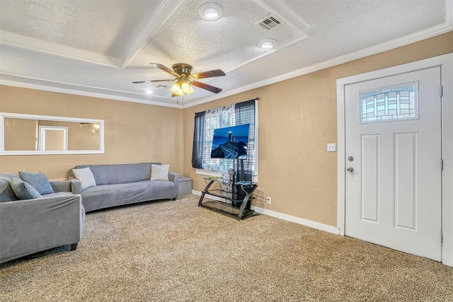 carpeted living room with a textured ceiling, ceiling fan, crown molding, and a tray ceiling