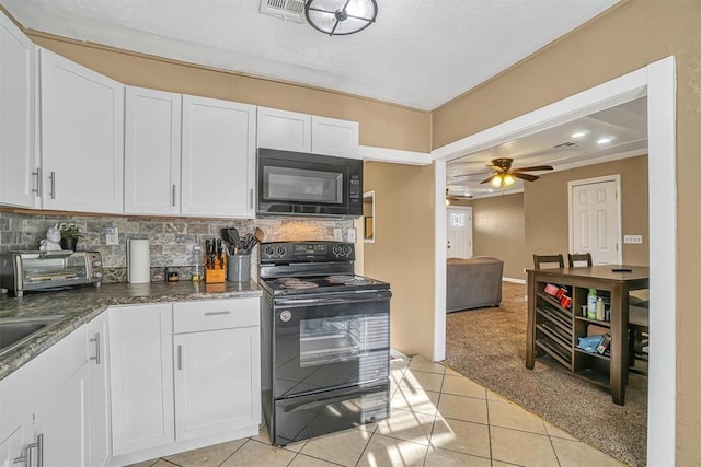 kitchen with white cabinetry, ceiling fan, backsplash, light colored carpet, and black appliances