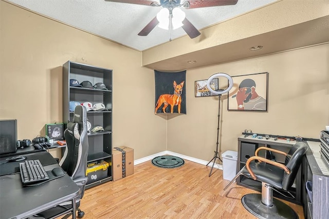 home office featuring a textured ceiling, hardwood / wood-style flooring, and ceiling fan