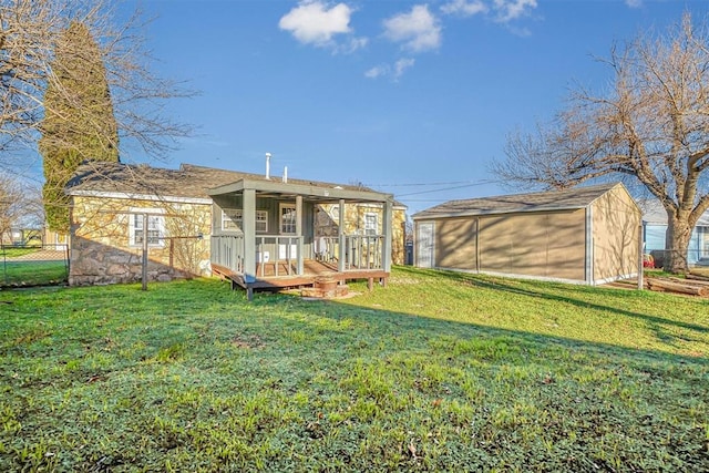 rear view of property featuring a yard and an outdoor structure